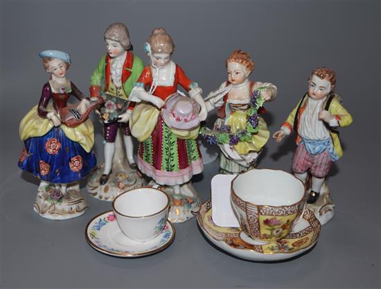 A pair of Samson figures of a couple, three small Thuringien figures and two miniature cups and saucers